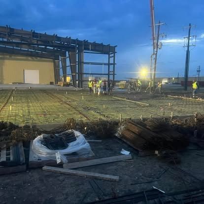 A group of construction workers are working on a building under construction.
