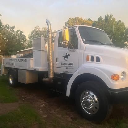 A white truck with a horse on the side is parked in the grass.