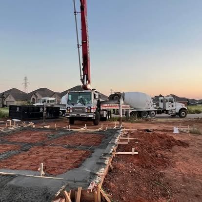 A concrete pump truck is pouring concrete on a construction site.