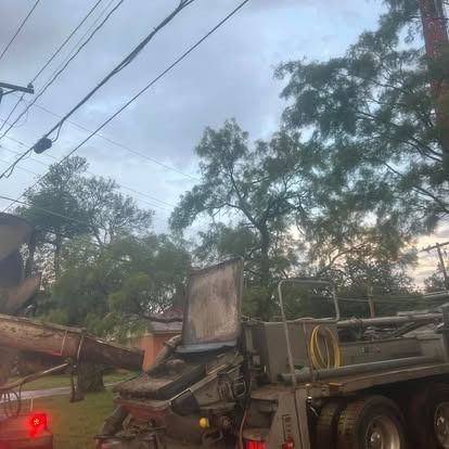 A concrete truck is pouring concrete into a yard.
