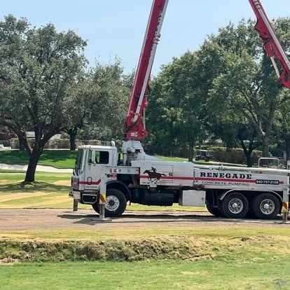 A renegade concrete pump truck is parked on the side of the road