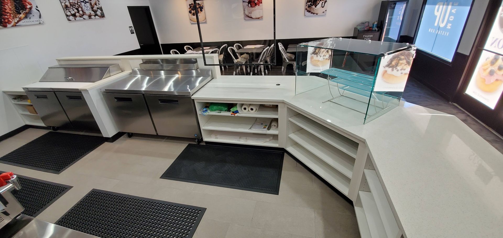 A kitchen with stainless steel cabinets and counter tops