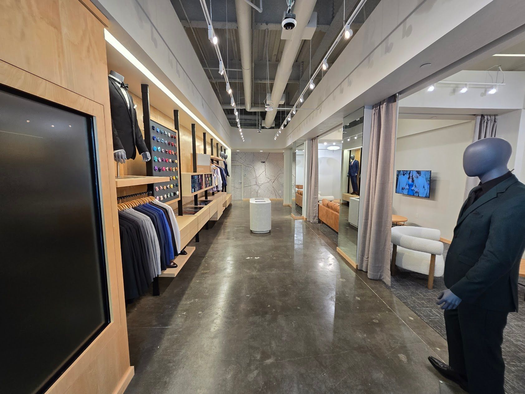 A mannequin in a suit is standing in a store.