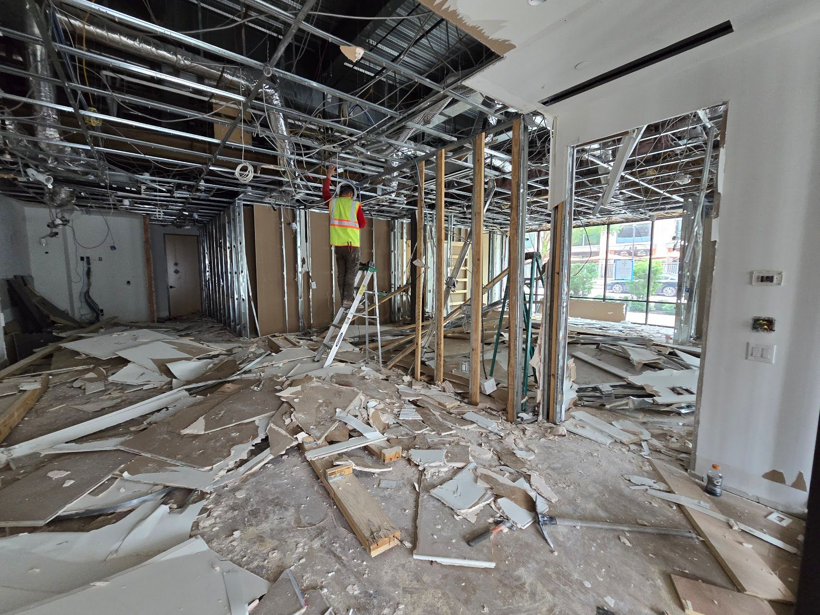 A man is standing in the middle of a building under construction.