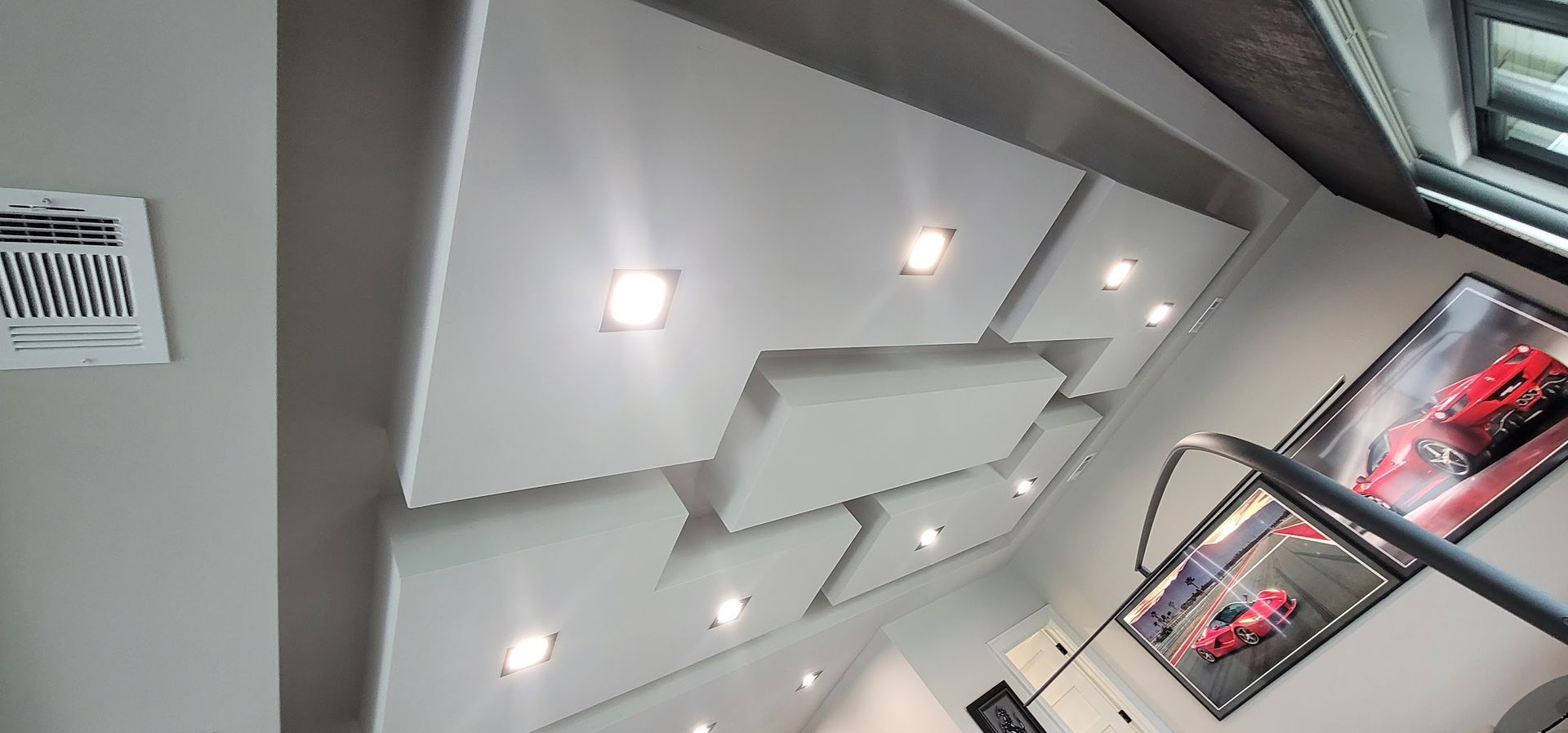 A room with a ceiling that has a picture of a red car on it