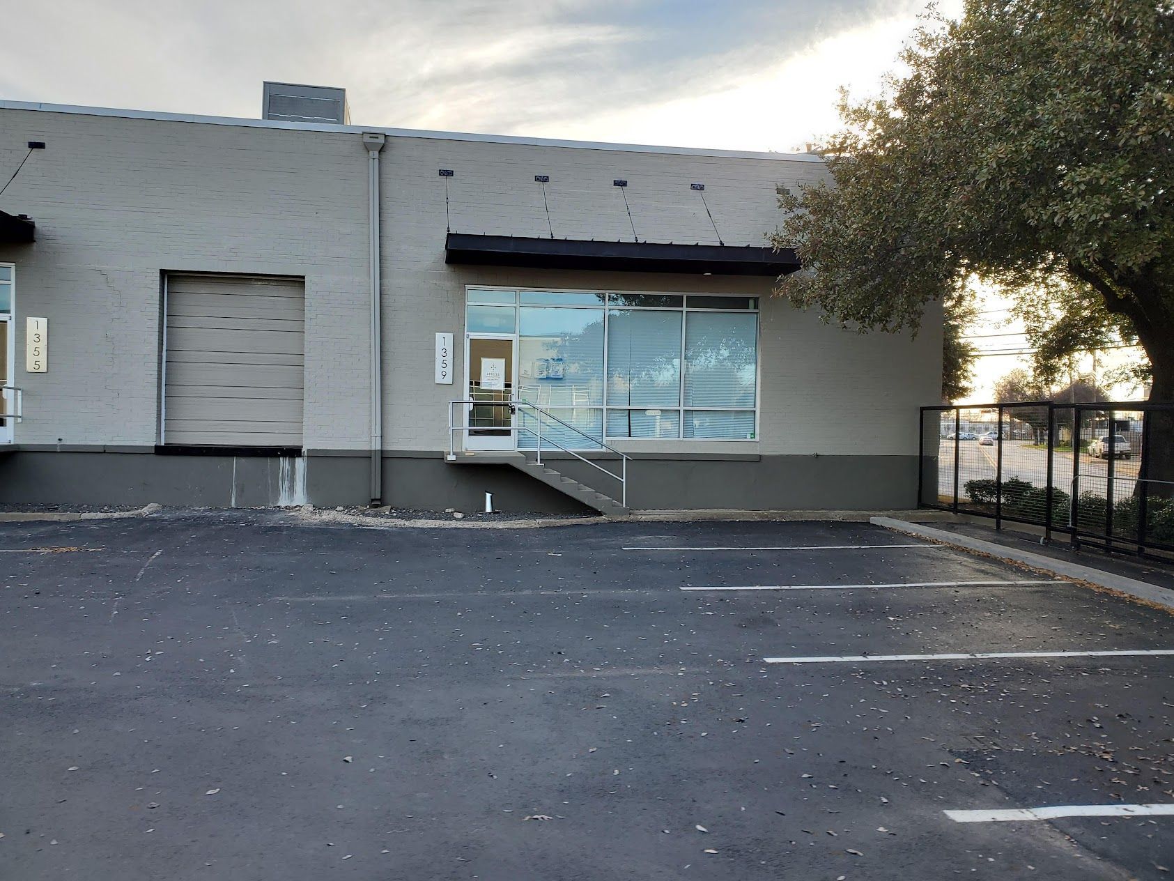 A parking lot in front of a building with a loading dock