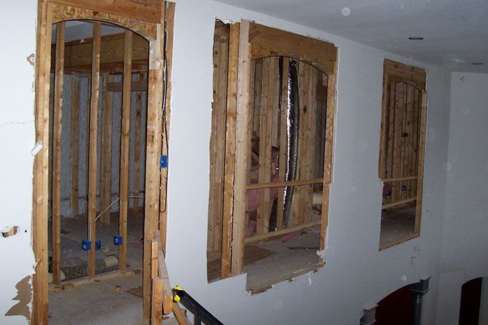 A building under construction with arched windows and a staircase
