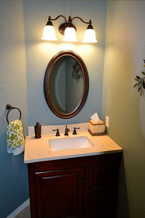 A bathroom with a sink and a mirror on the wall