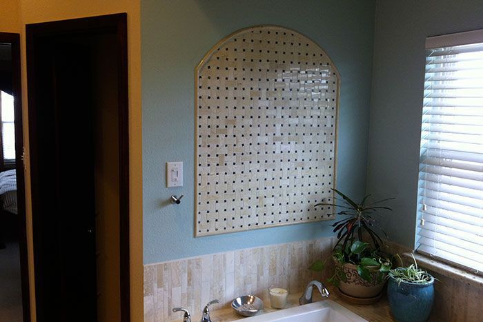 A bathroom with a sink and a window with blinds.