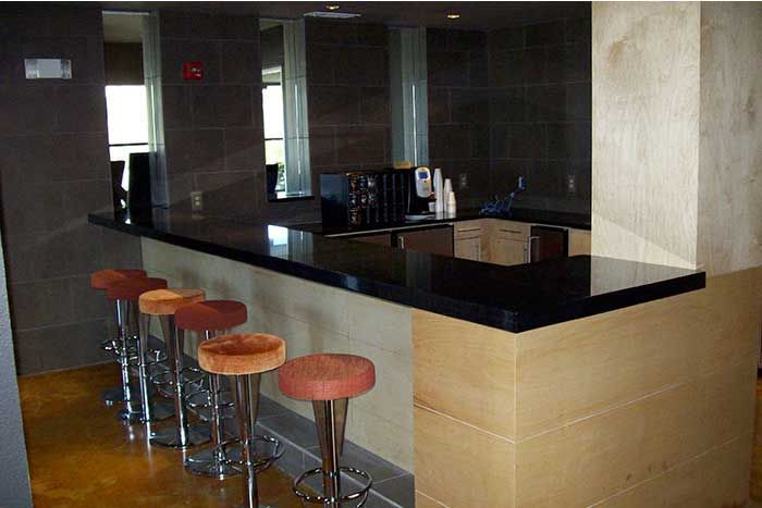 A kitchen with a bar and stools in it