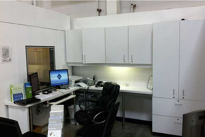 A desk with a computer on it and a chair