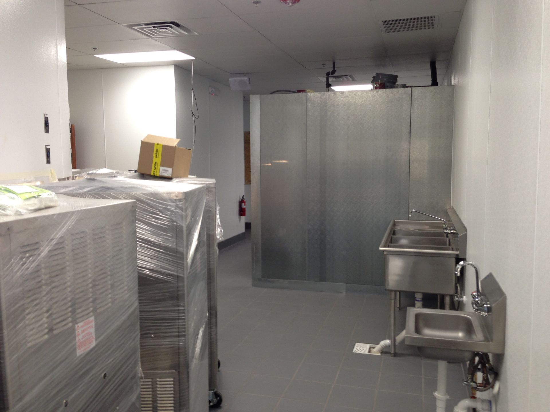 A kitchen with a sink and a box on top of it