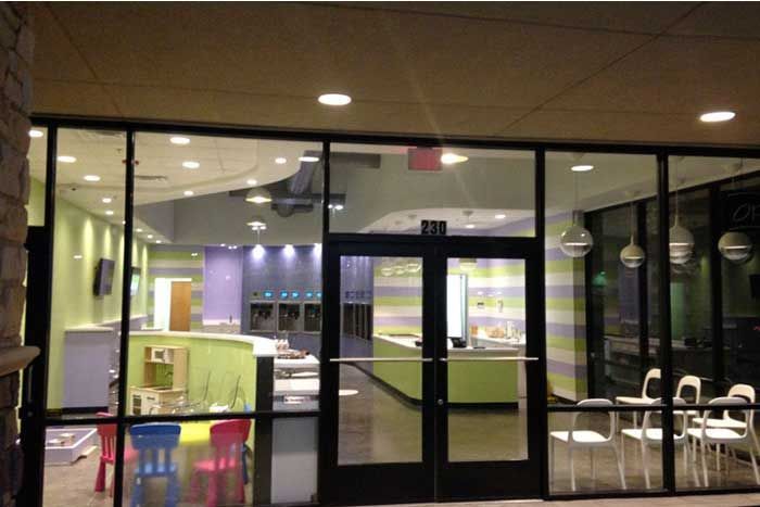 A building with a lot of windows and chairs in front of it