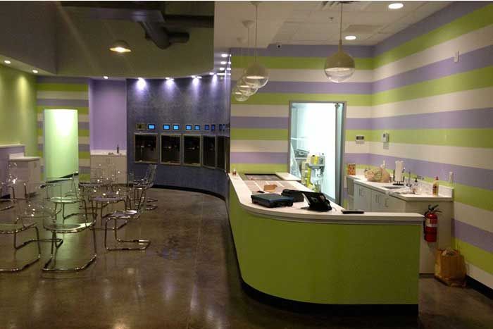 A restaurant with purple and green stripes on the walls