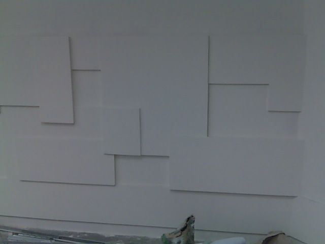 A white wall with a geometric pattern on it