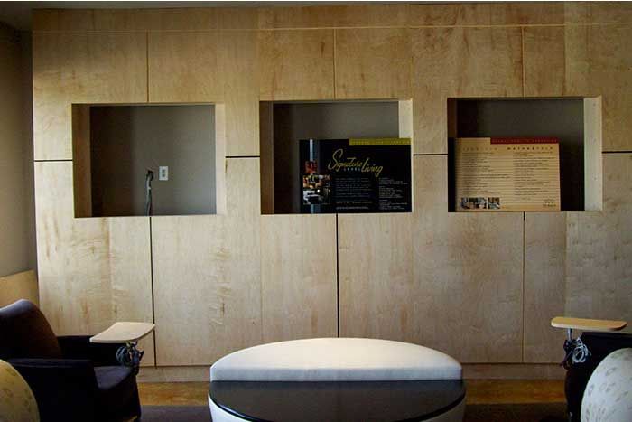 A living room with a round ottoman and a chair