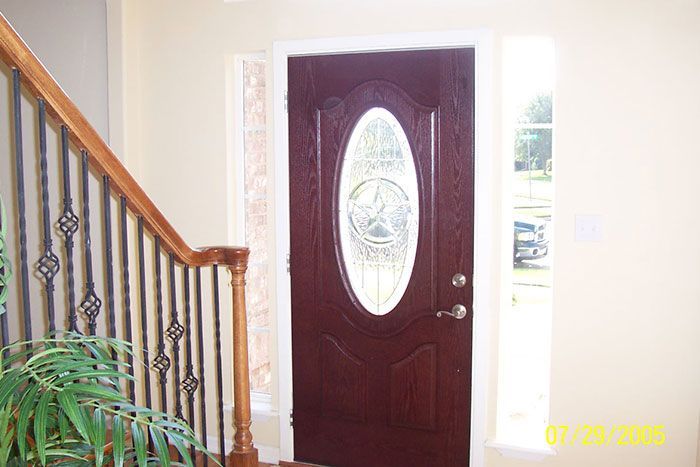 A picture of a door and stairs in a house