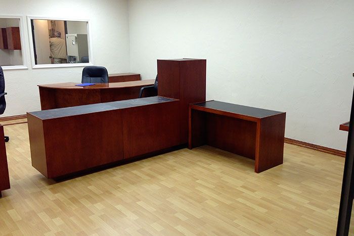 An office with a wooden desk and chairs