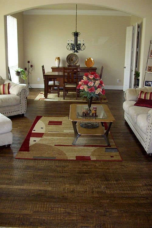 A living room with a dining room table and chairs