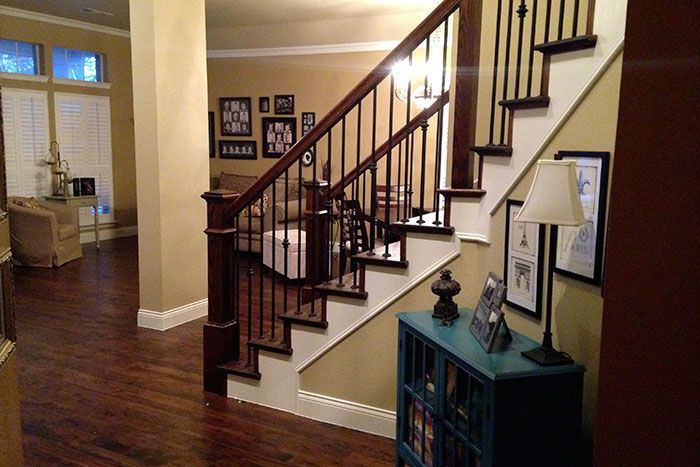 A staircase in a house with a lamp on the side