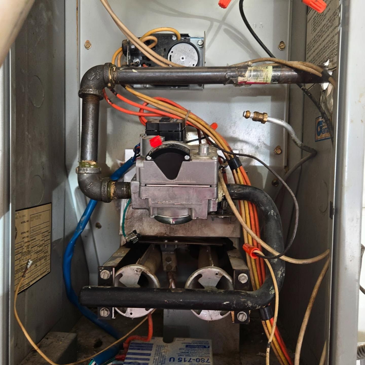 The inside of a boiler with a few wires coming out of it