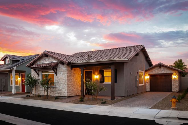 A row of houses with a sunset in the background.