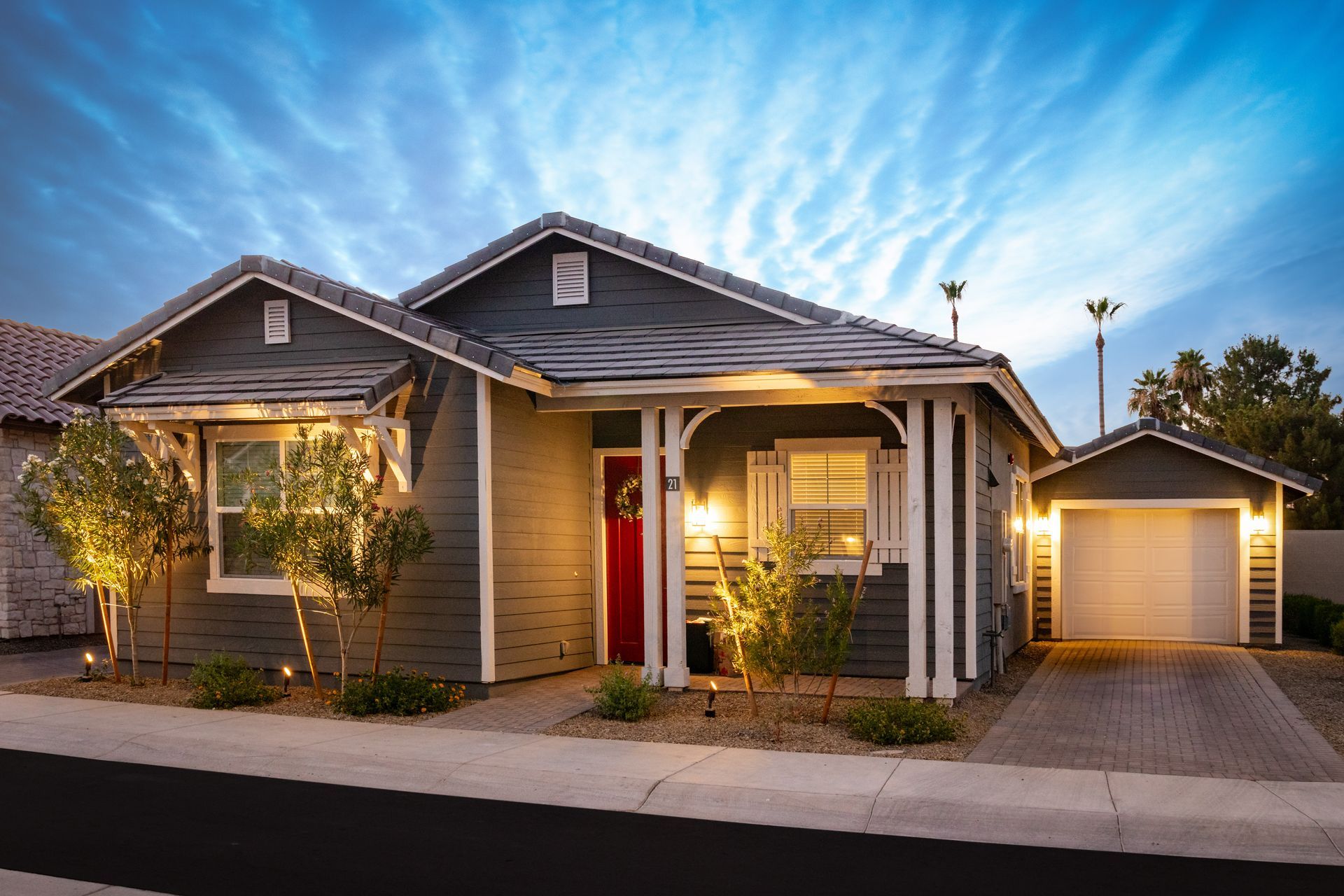 A house with a red door is lit up at night