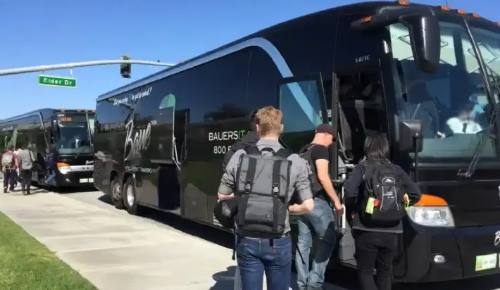 A black suv is parked in front of a private jet