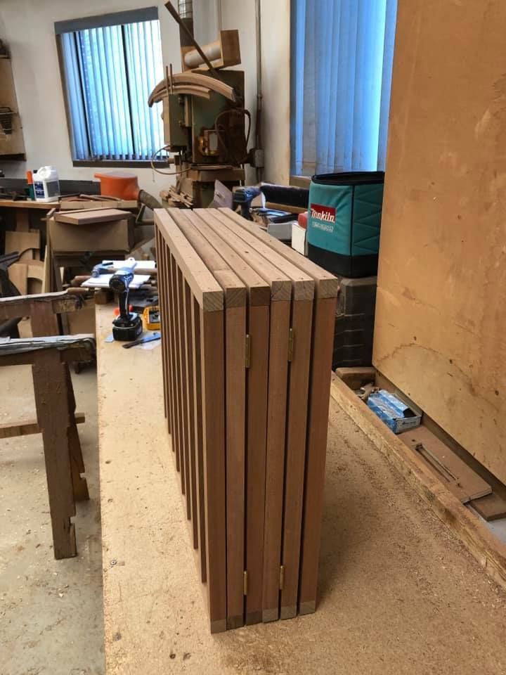A wooden cabinet with two doors and two drawers on a white background.