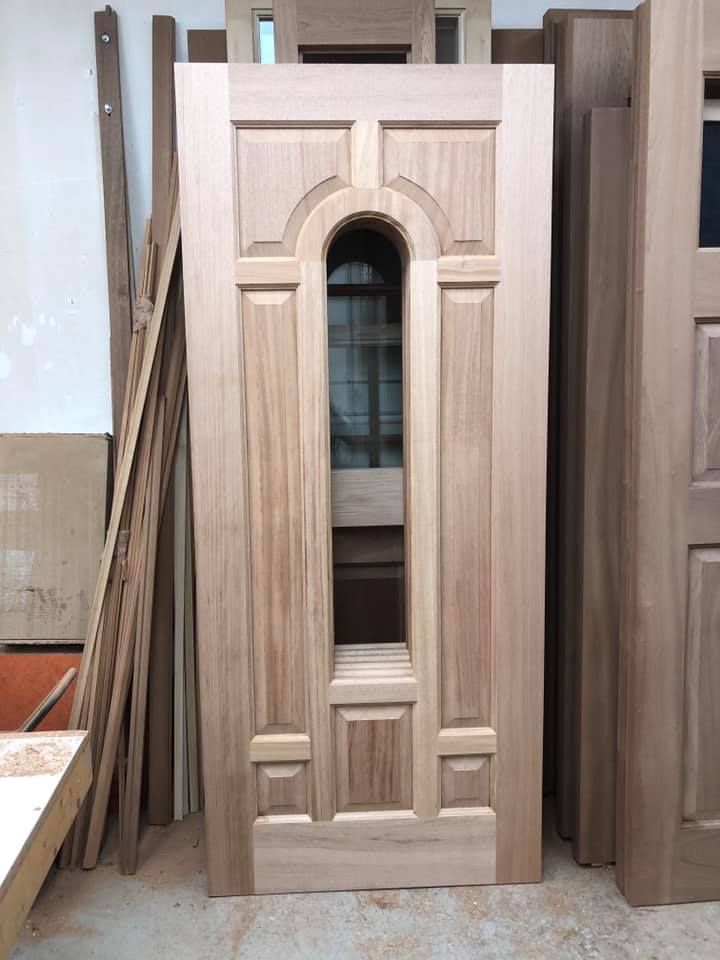 A wooden door with a window in the middle of it