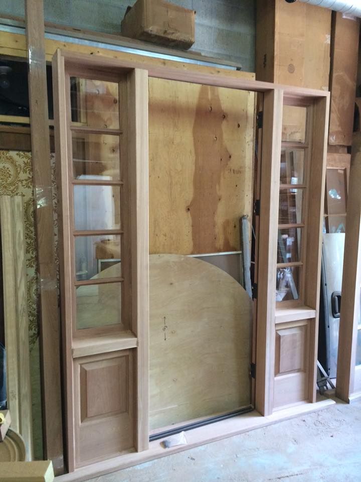 A wooden door is being built in a workshop