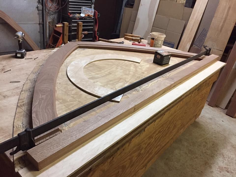 A large piece of wood is sitting on top of a wooden table.
