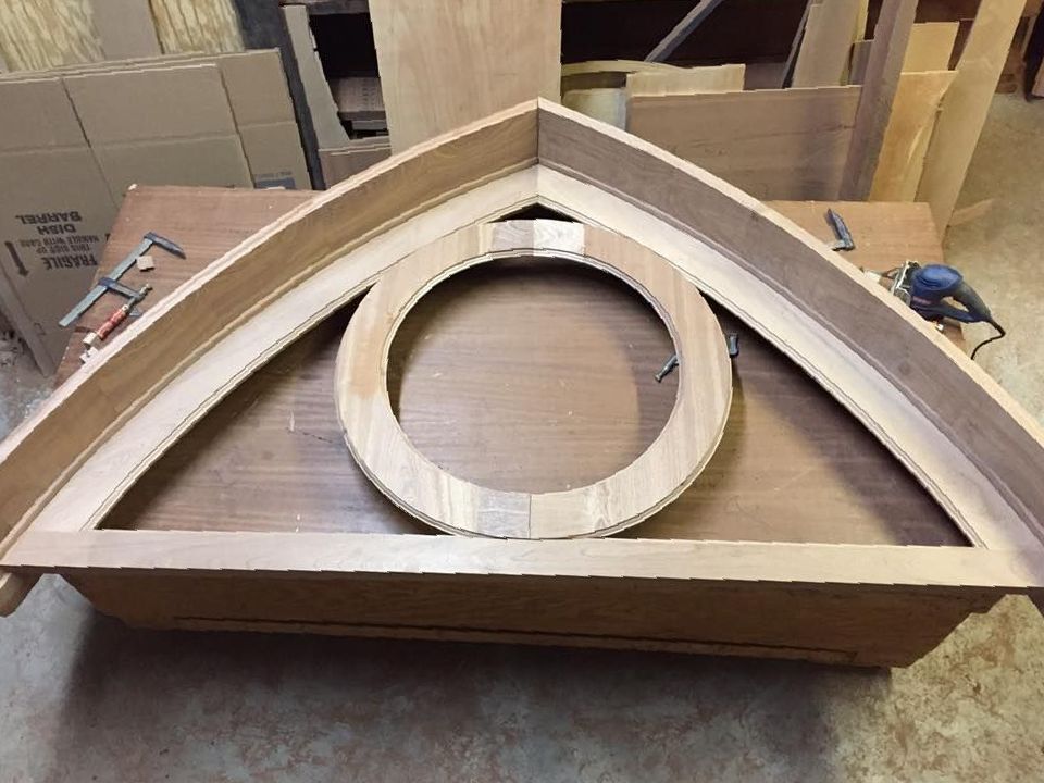 A black front door with a window and flowers in front of it