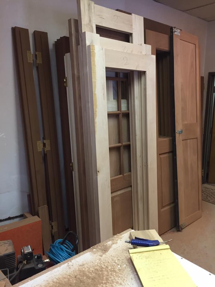 There is a wooden door in the middle of a stone wall.