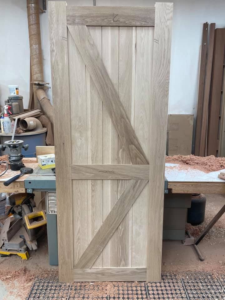 A wooden door is being made in a workshop.