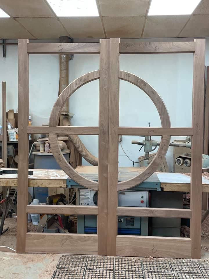 A wooden door is being made in a workshop
