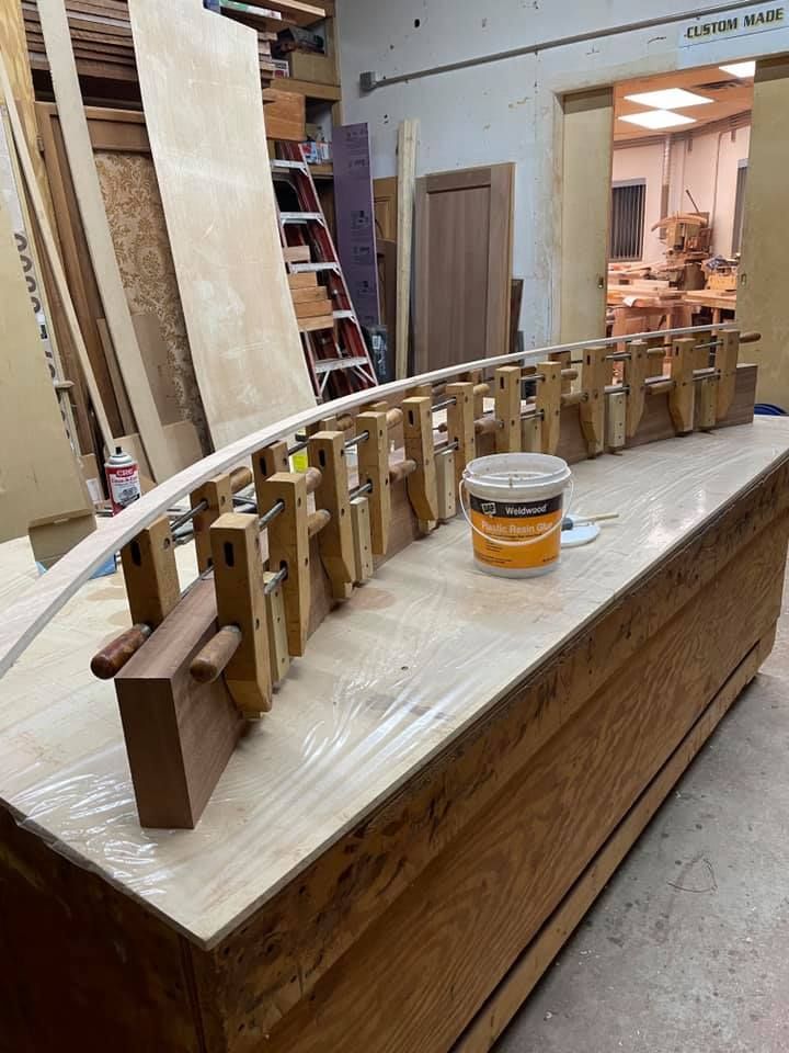 A wooden table with a bucket of glue on it in a workshop.