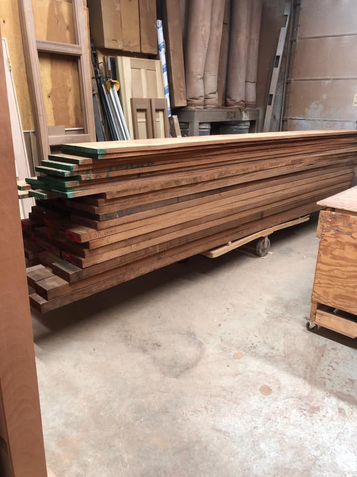 A row of doors of different colors and sizes are lined up in a room.