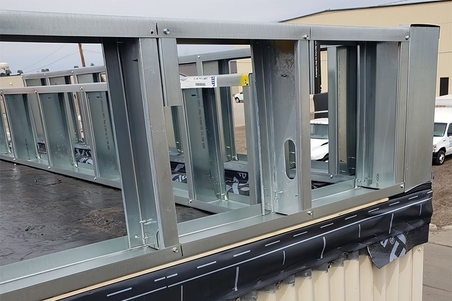 The Air Force Base Building 725 in Minot, North Dakota, shows EPDM repair and a new metal Parapet Wall.