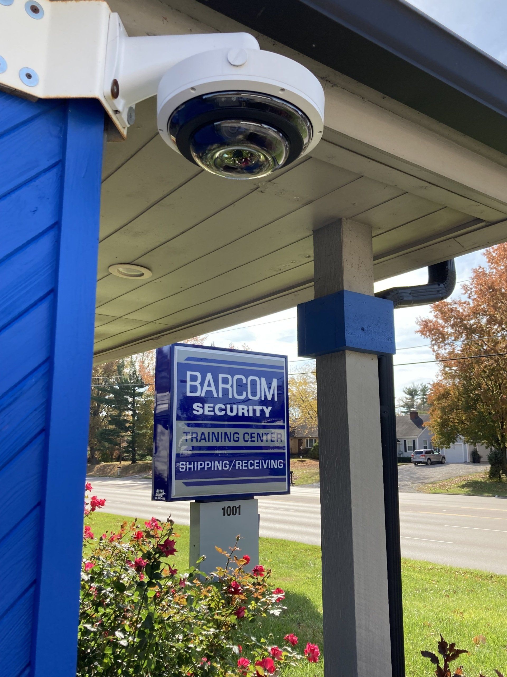 A blue building with a sign that says barcom security