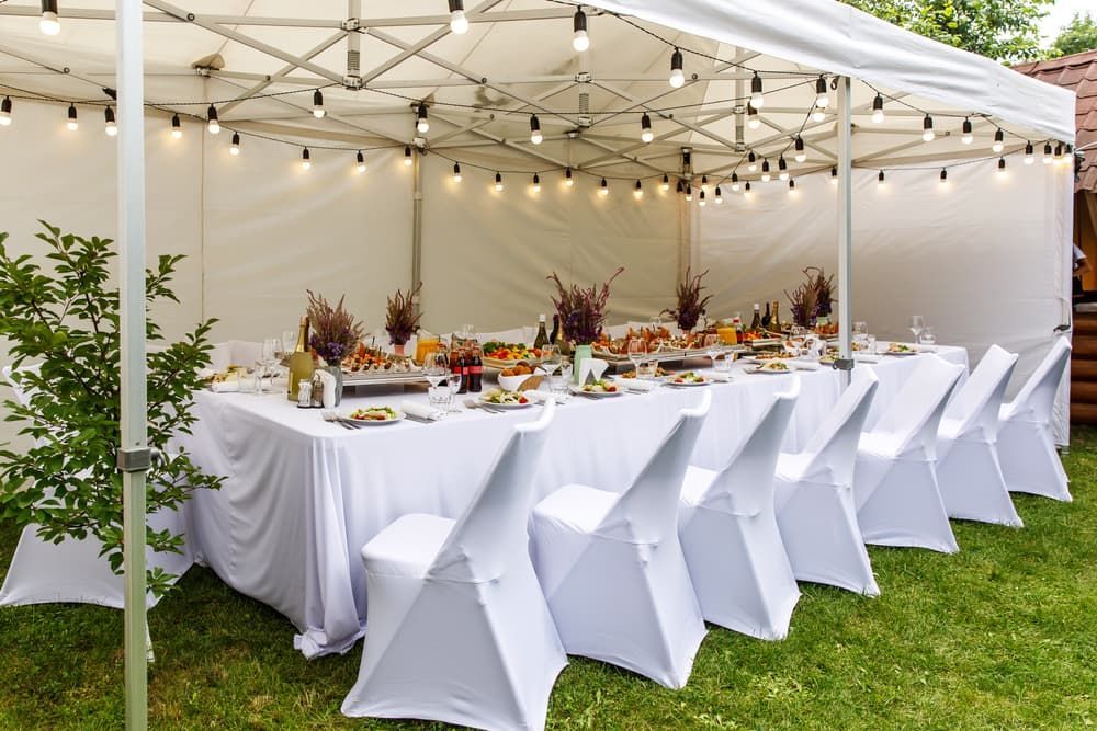 A Long Table and Chairs Under a Tent in The Grass — Brews & Bites Beachside Cafe in Meikleville Hill, QLD