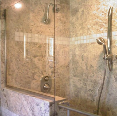 A shower with a glass door and a shower head.