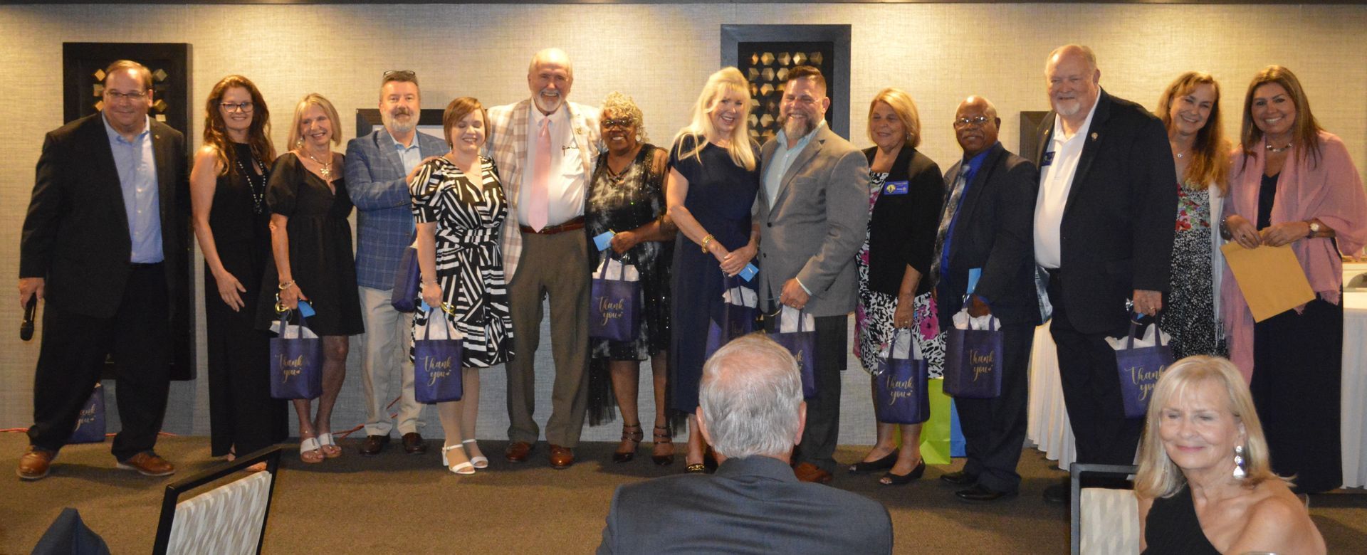 A group of people are posing for a picture in a room.