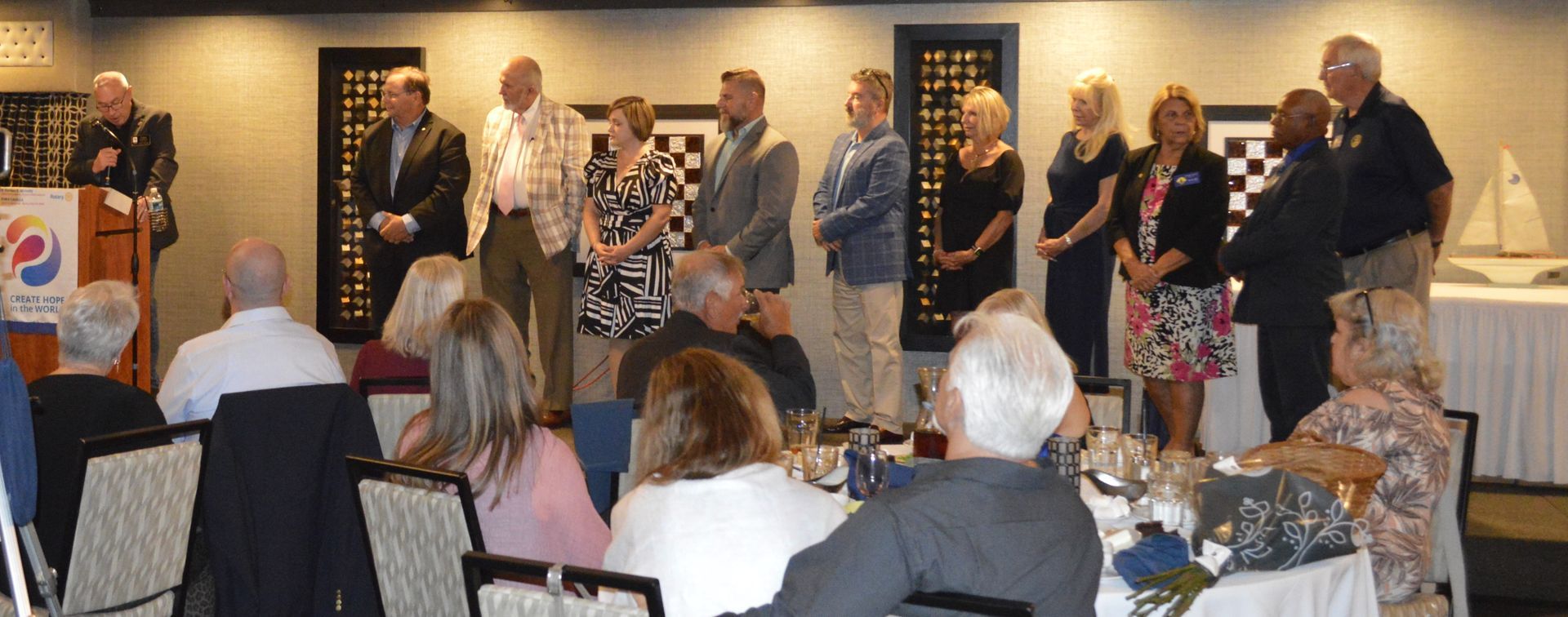 A group of people are sitting at tables in a room.