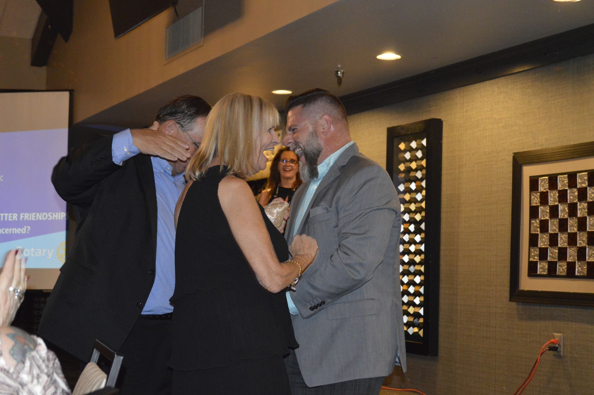 A man and a woman are standing next to each other in a room.