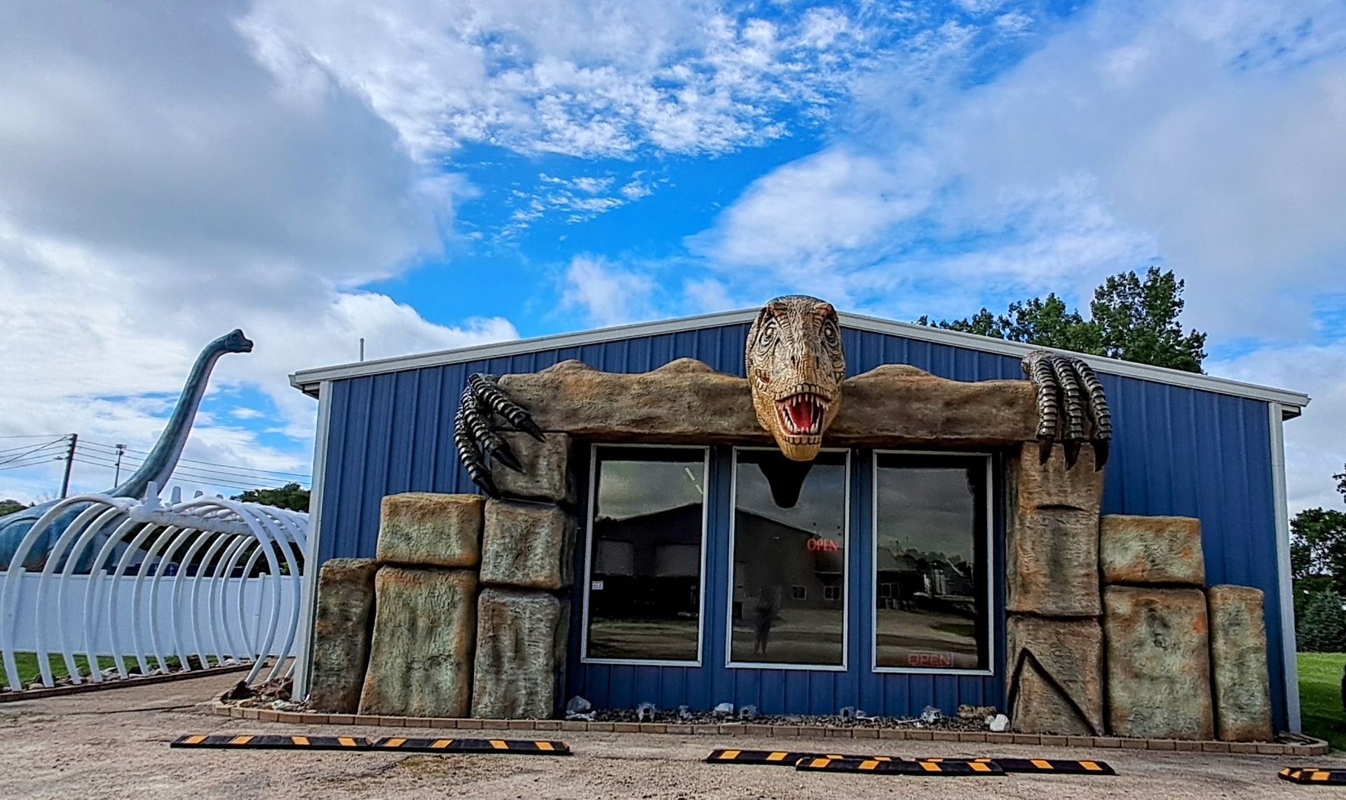 Boneyard Creation Museum with a dinosaur skeleton in front of it.