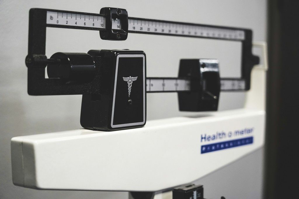 Health meter with black balance scale on a white medical device