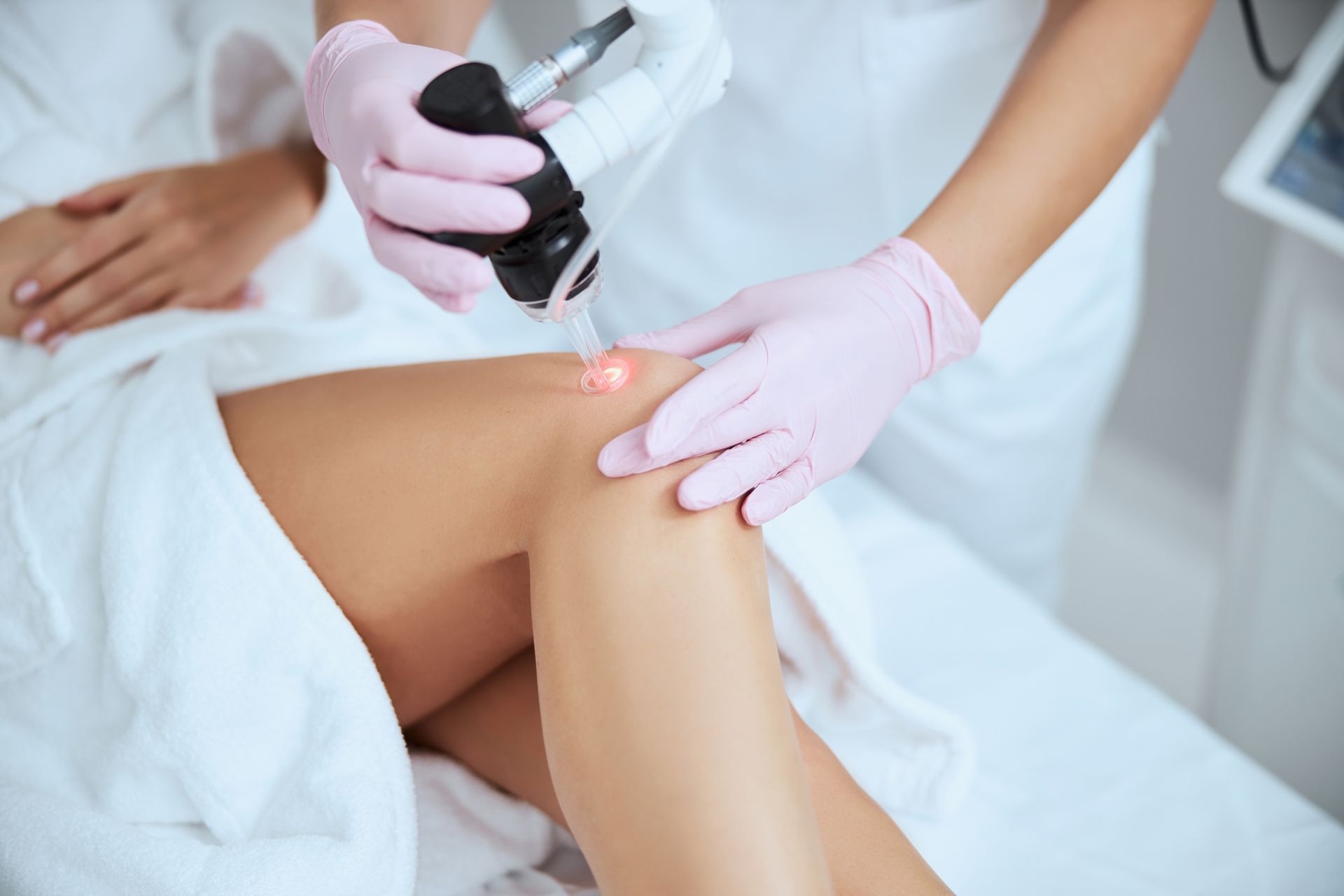 woman receiving leg vein treatment in a clinic