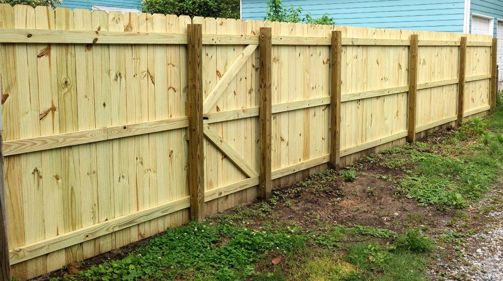 A new fence installation constructed of wood