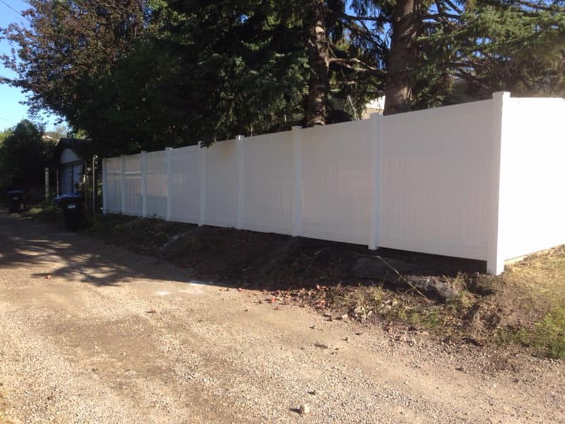 Brand new vinyl fence installation on a residential property